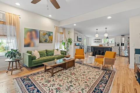 a living room with furniture and wooden floor