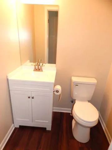 a bathroom with a toilet a sink and a mirror