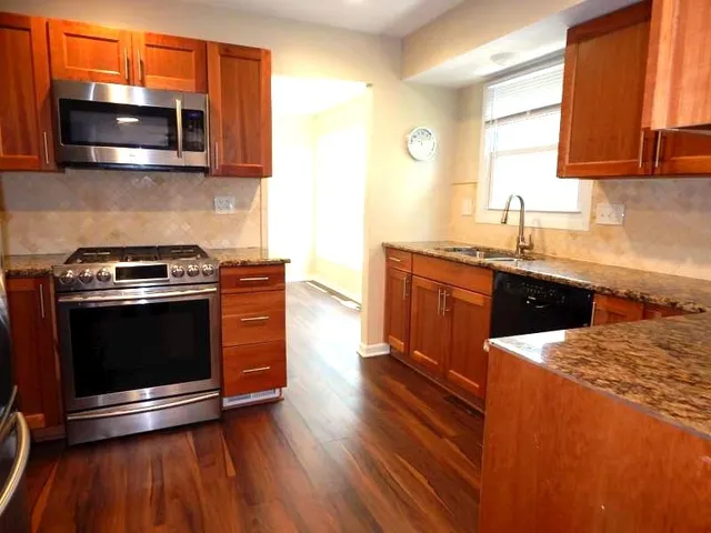 a kitchen with stainless steel appliances a stove a microwave sink and cabinets