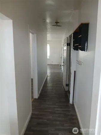 a view of a hallway with the wooden floor