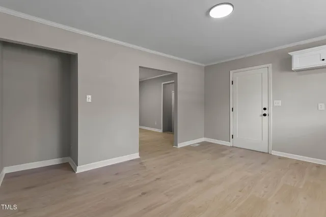 a view of an empty room with wooden floor