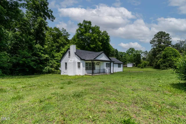 a view of a house with yard and a garden