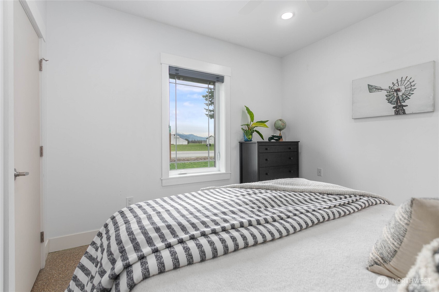 7393 Hannegan Road Lynden, WA 98264 - Photo 17 of 29 a bedroom with a bed and a window