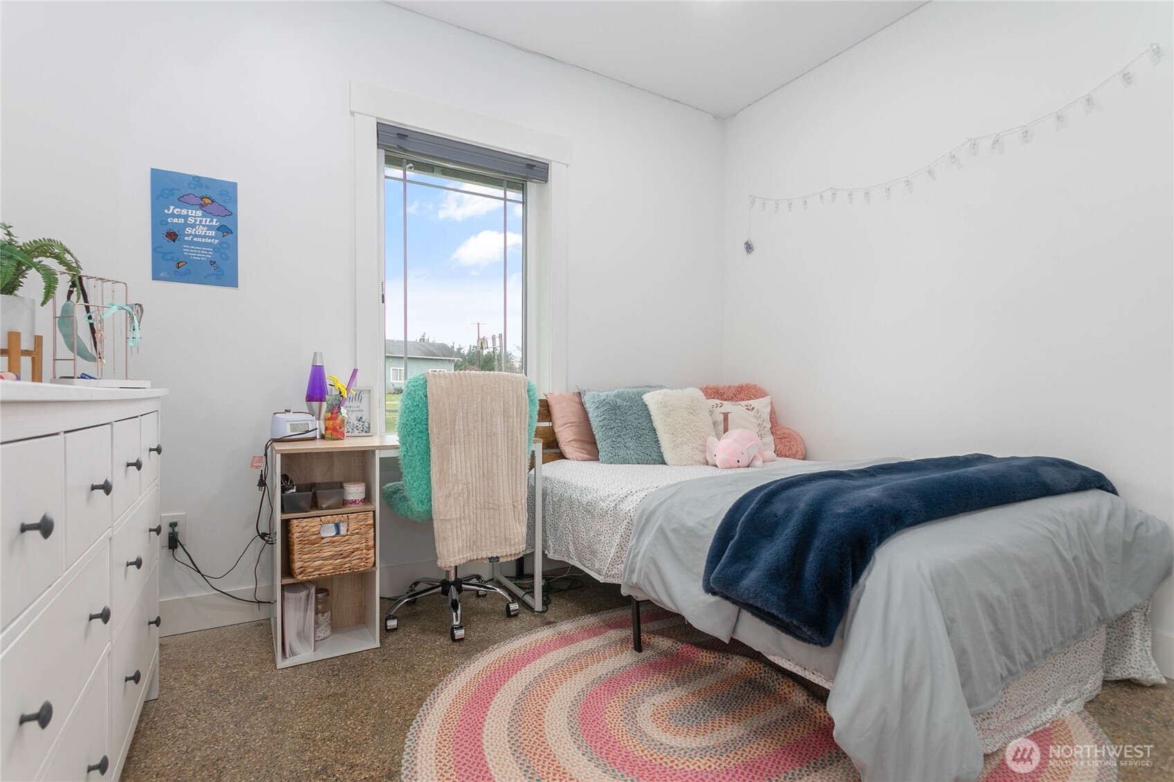 7393 Hannegan Road Lynden, WA 98264 - Photo 18 of 29 a bed room with a bed and a chair