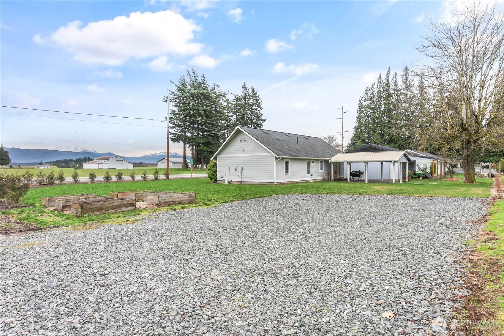 7393 Hannegan Road Lynden, WA 98264 - Photo 2 of 29 a house with green field in front of it