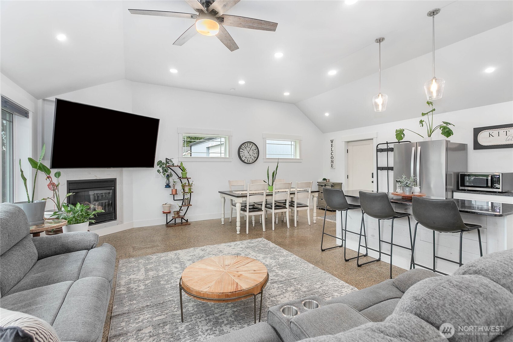 7393 Hannegan Road Lynden, WA 98264 - Photo 4 of 29 a living room with furniture a flat screen tv and a fireplace
