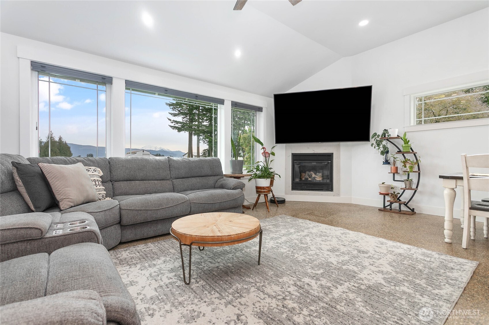7393 Hannegan Road Lynden, WA 98264 - Photo 5 of 29 a living room with furniture a flat screen tv and a fireplace