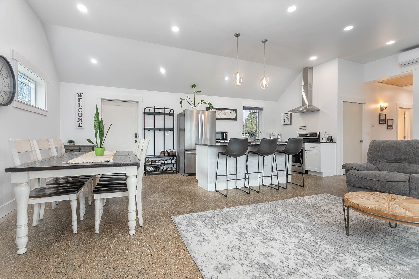 7393 Hannegan Road Lynden, WA 98264 - Photo 7 of 29 a living room with lots of furniture and a dining table