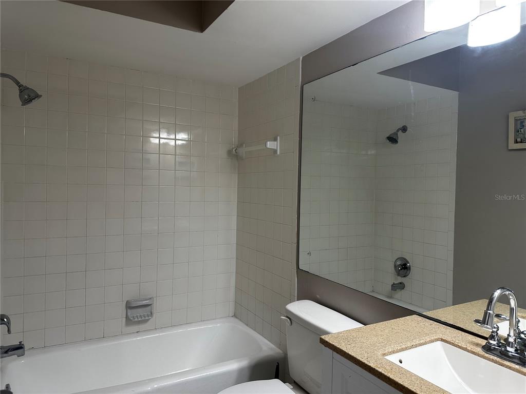 5434 Saddlebrook Way, Unit 3 Wesley Chapel, FL 33543 - Photo 13 of 17 a bathroom with a sink a toilet and shower