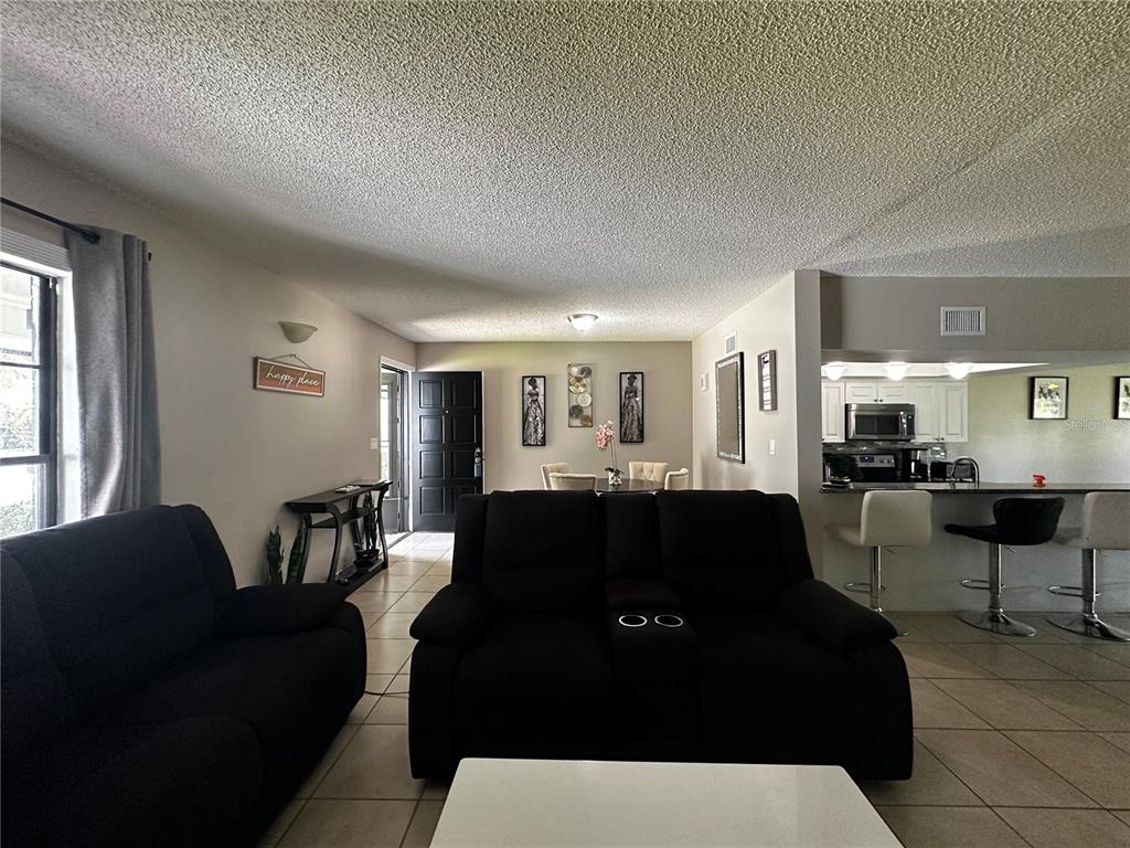 5434 Saddlebrook Way, Unit 3 Wesley Chapel, FL 33543 - Photo 4 of 17 a living room with furniture and a large window