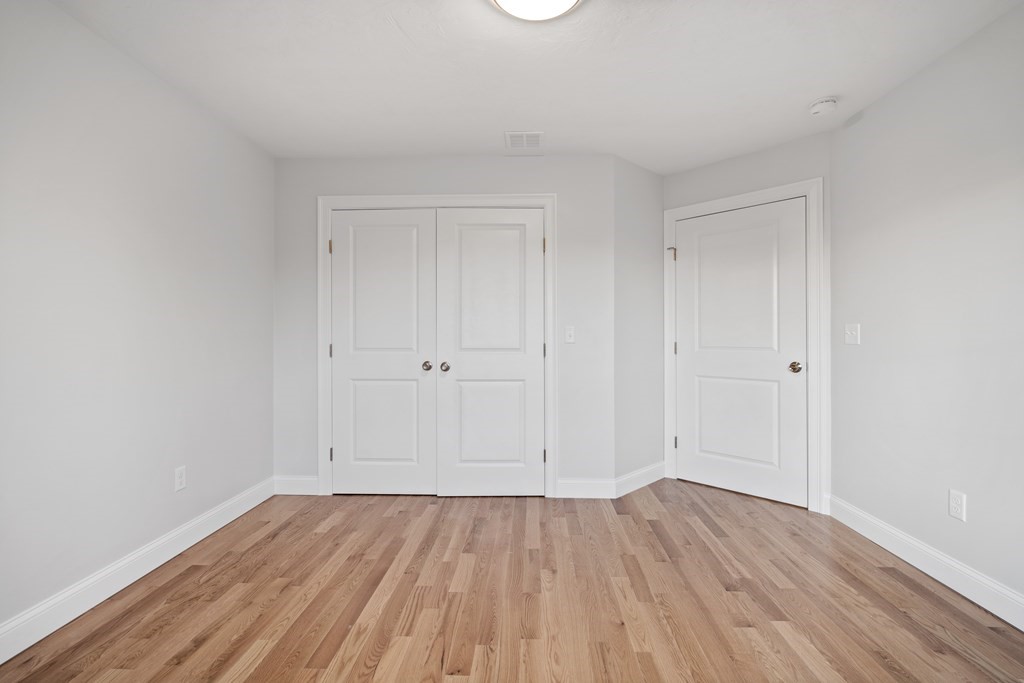 108 High Street, Unit B Wareham, MA 02571 - Photo 23 of 31 a view of an empty room with wooden floor