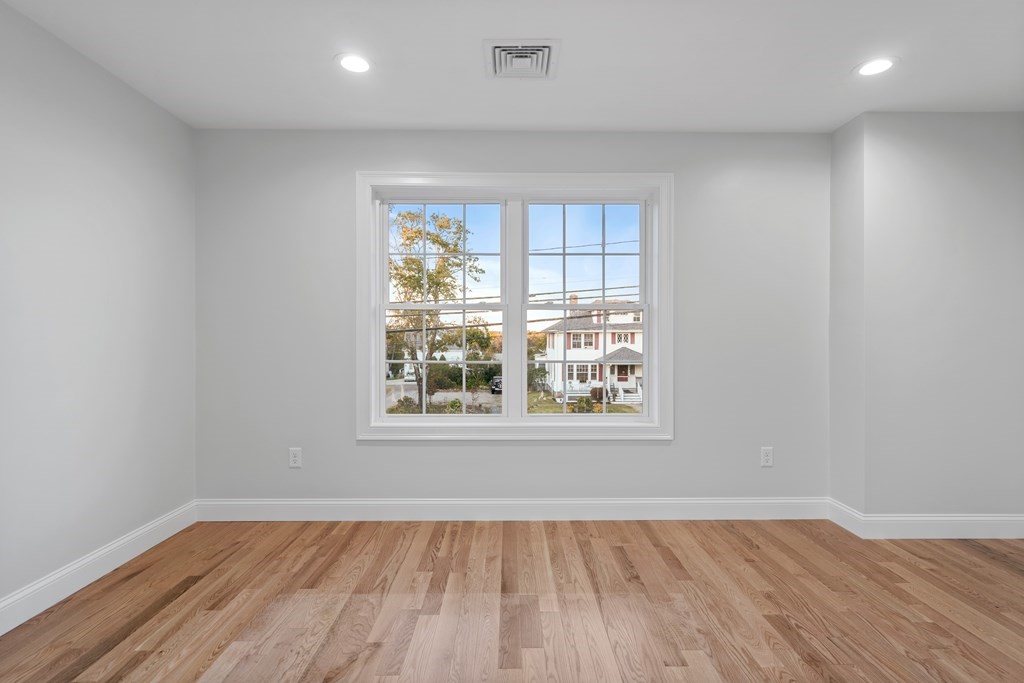 108 High Street, Unit B Wareham, MA 02571 - Photo 28 of 31 an empty room with wooden floor and windows