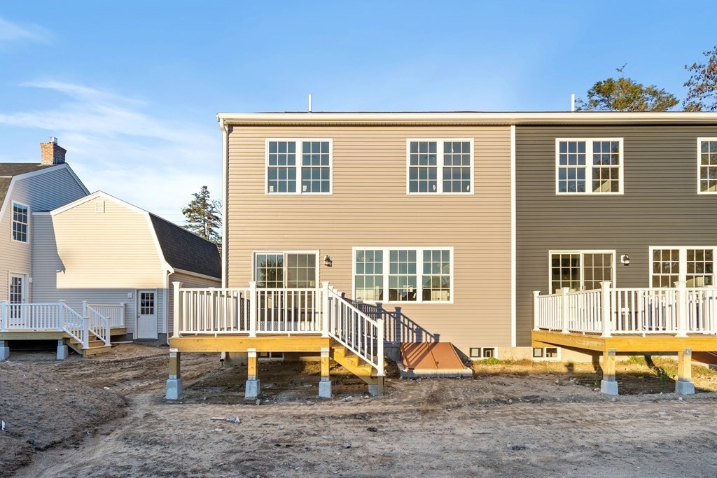 108 High Street, Unit B Wareham, MA 02571 - Photo 3 of 31 a backyard of a house with barbeque oven table and chairs