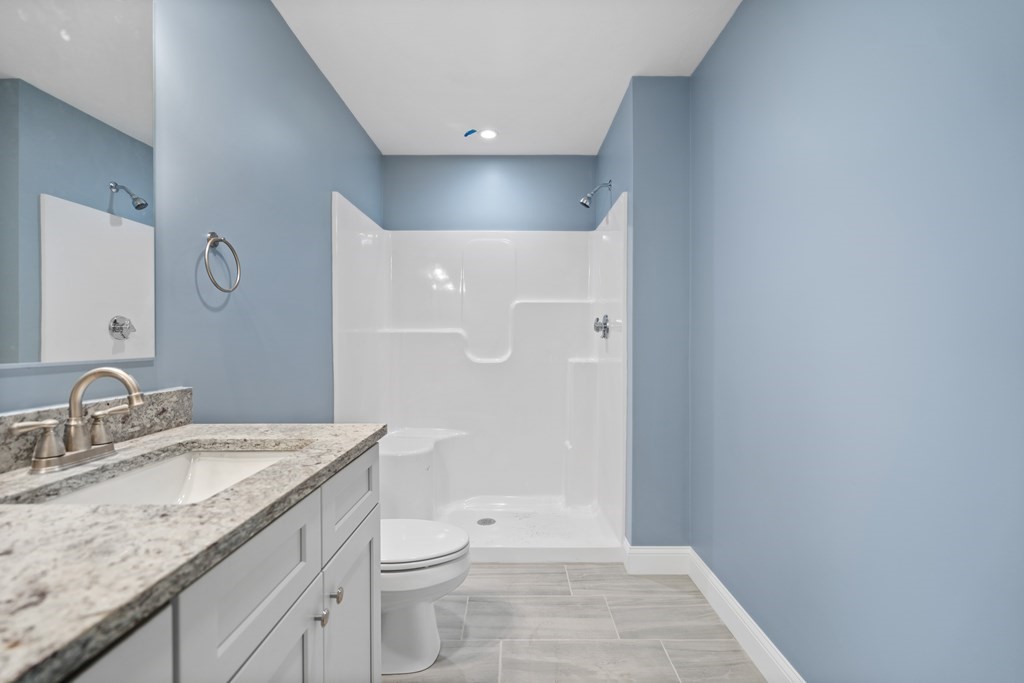 108 High Street, Unit B Wareham, MA 02571 - Photo 31 of 31 a bathroom with a granite countertop sink a toilet and shower