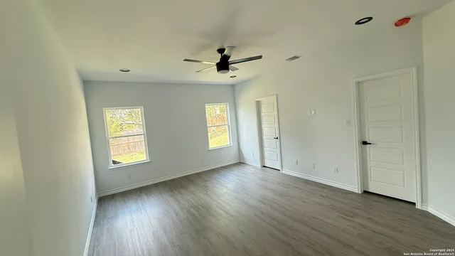 wooden floor in an empty room with a window