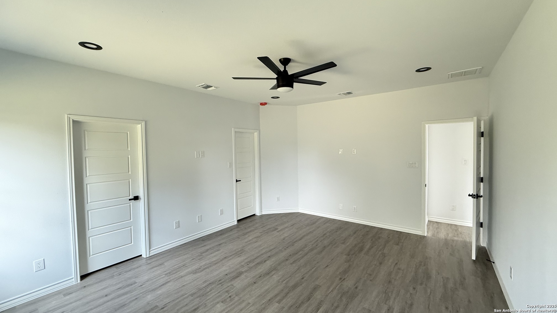 124 Lookout Court Spring Branch, TX 78070 - Photo 22 of 28 an empty room with wooden floor and a ceiling fan