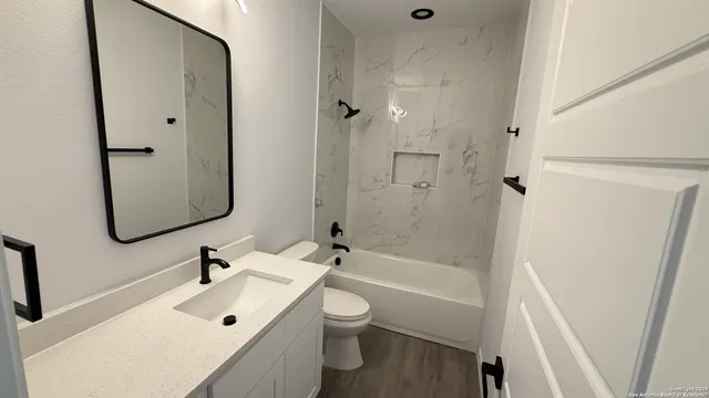 a bathroom with a sink toilet tub and shower