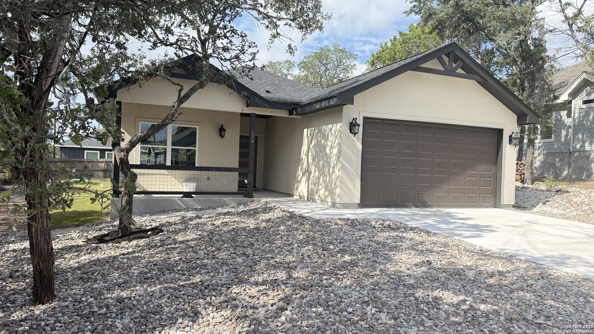124 Lookout Court Spring Branch, TX 78070 - Photo 4 of 28 a front view of a house with a yard and garage