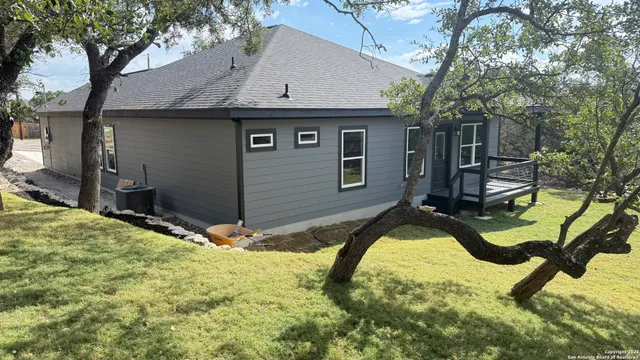 a view of a house with pool yard and sitting area