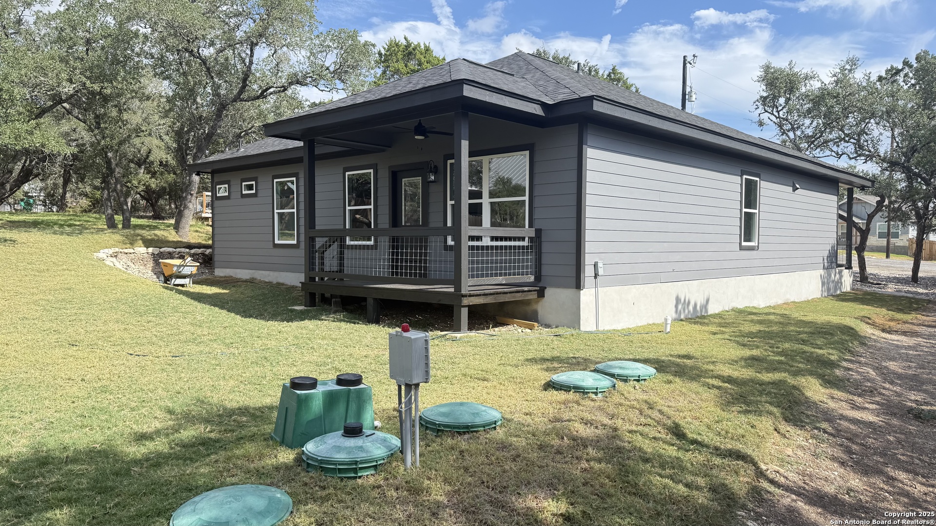 124 Lookout Court Spring Branch, TX 78070 - Photo 9 of 28 a backyard of a house with barbeque oven table and chairs