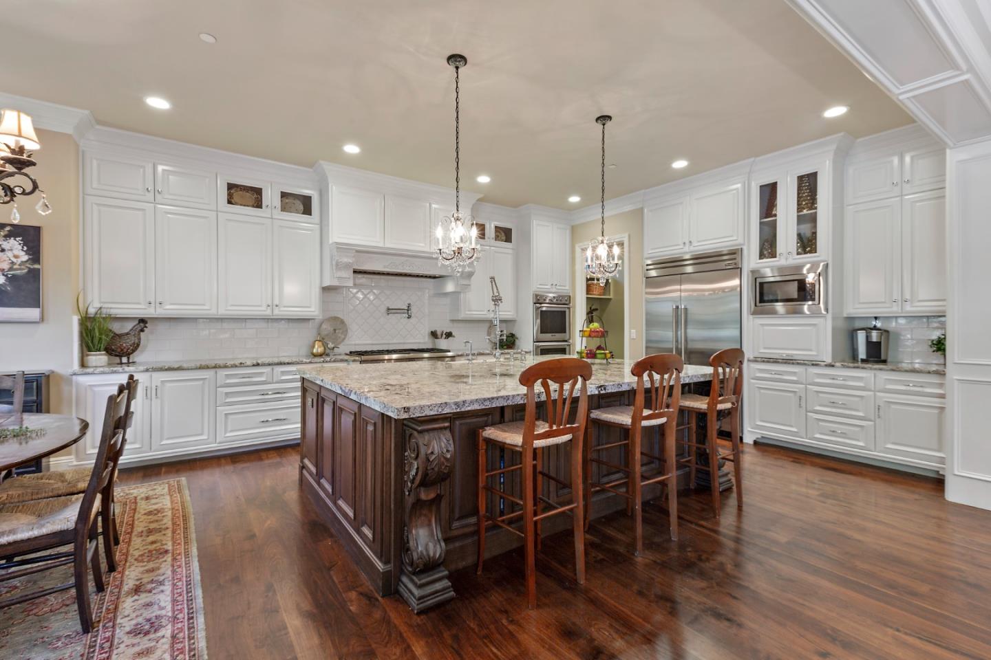 1187 Clark Way San Jose, CA 95125 - Photo 35 of 81 a kitchen with stainless steel appliances kitchen island granite countertop a wooden floor and white cabinets