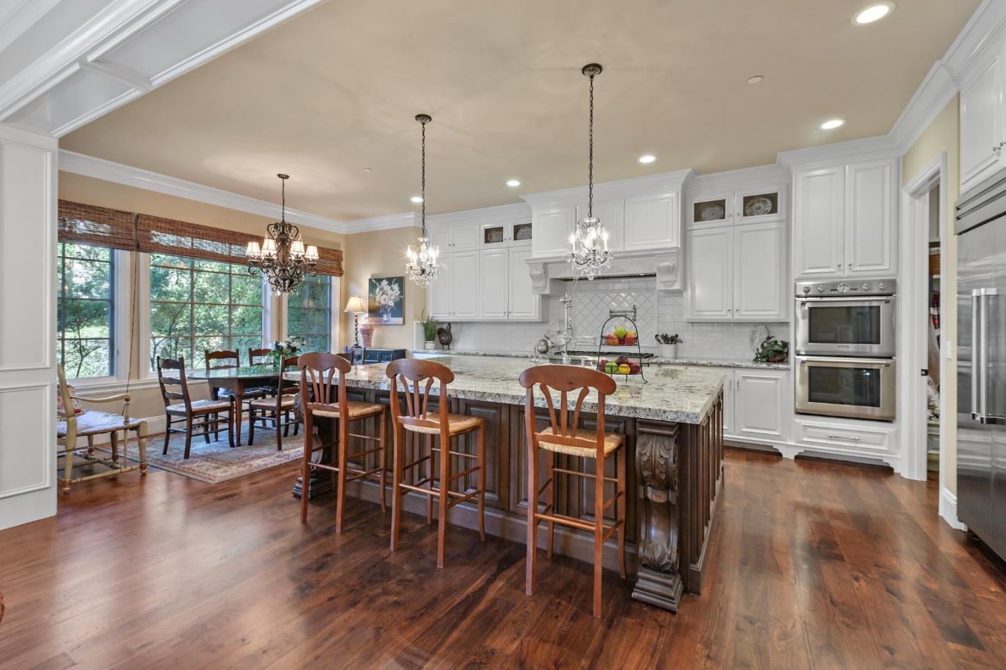 1187 Clark Way San Jose, CA 95125 - Photo 36 of 81 a kitchen with stainless steel appliances granite countertop a dining table chairs stove and white cabinets