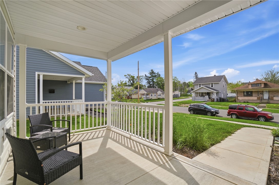728 East Northern Avenue Springfield, OH 45503 - Photo 5 of 35 Relax on the inviting porch overlooking a quiet street, perfect for peaceful mornings.