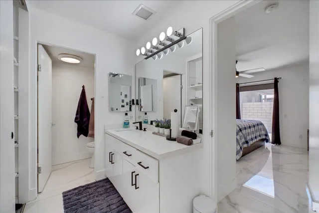 a bathroom with a double vanity sink a mirror a vanity and shower