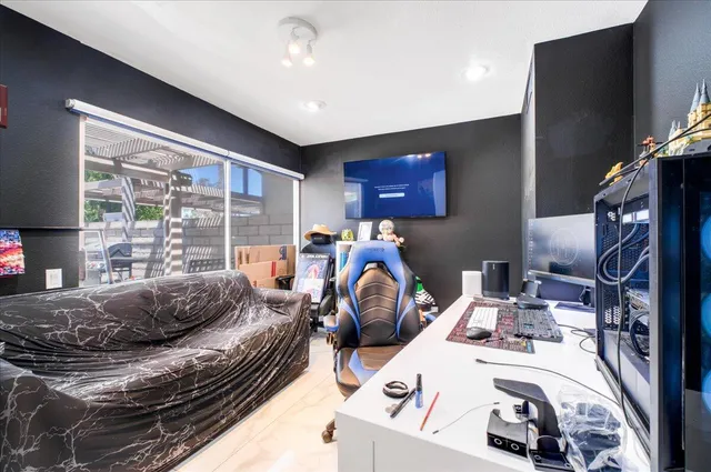 a bed room with a bed and a television