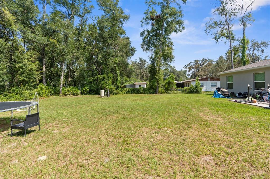 5637 East Tangelo Lane Inverness, FL 34453 - Photo 22 of 23 a backyard of a house with table and chairs