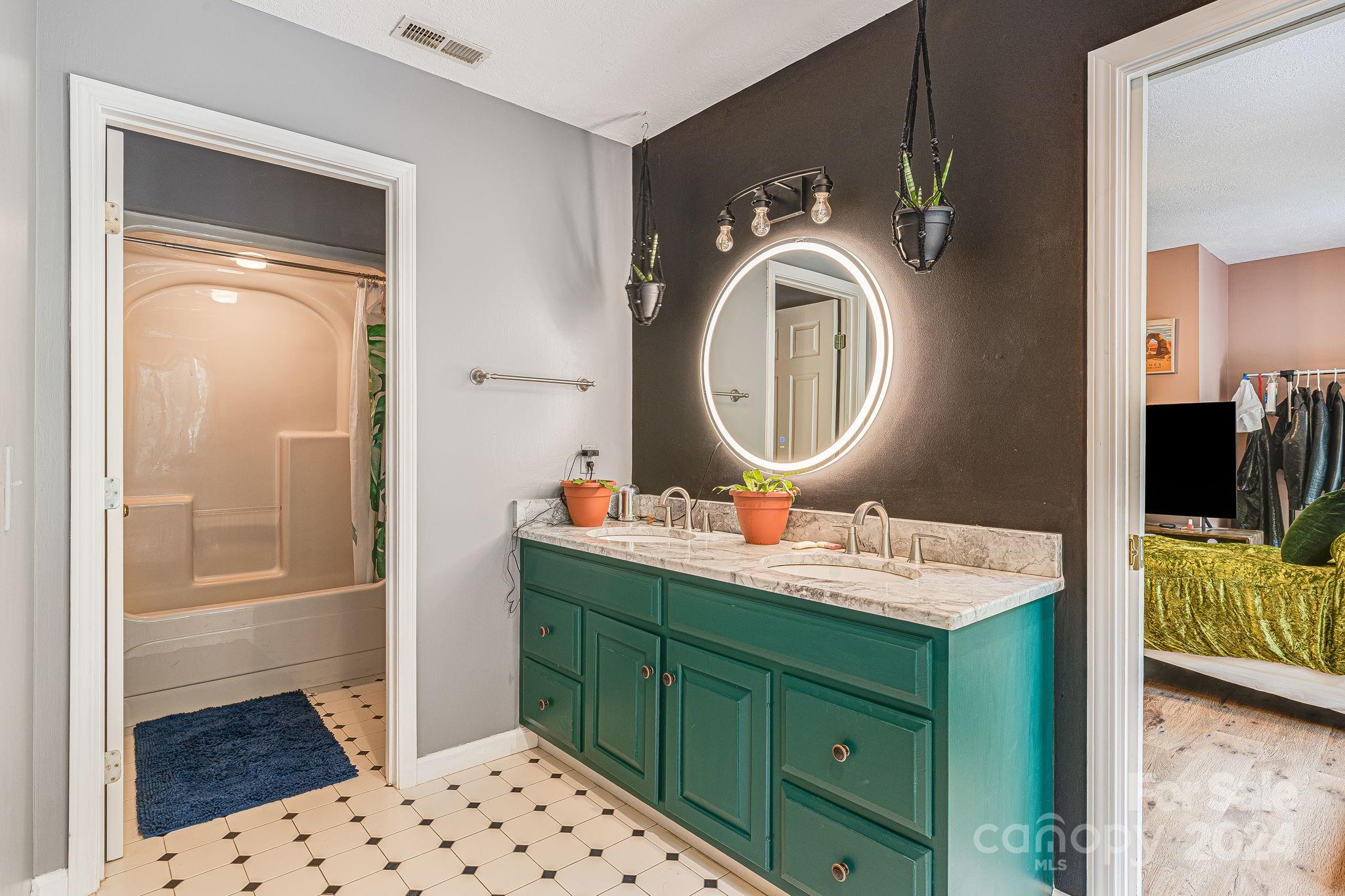 116 Holcombe Cove Road Candler, NC 28715 - Photo 19 of 31 a bathroom with a sink a toilet and mirror