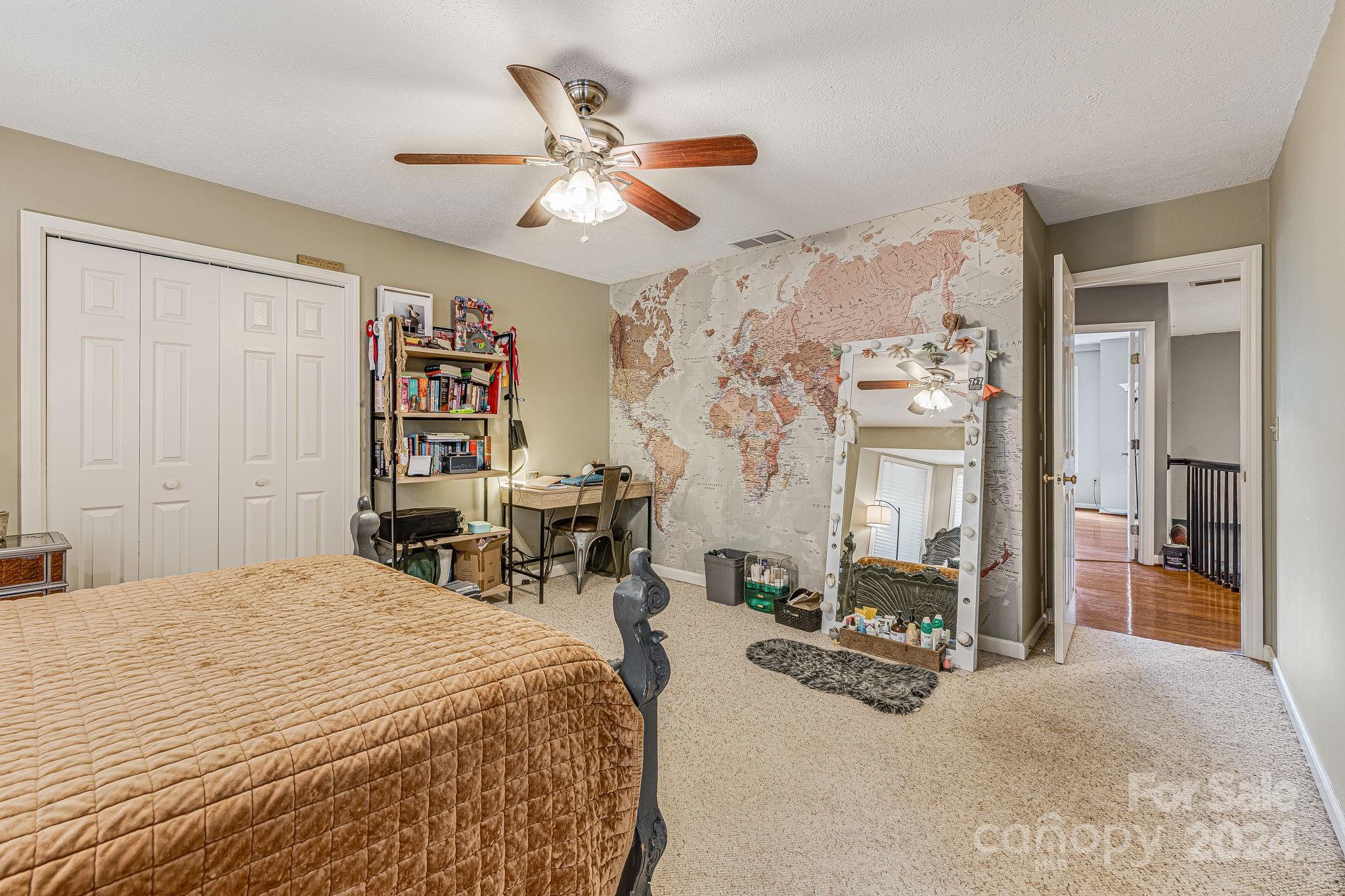 116 Holcombe Cove Road Candler, NC 28715 - Photo 23 of 31 a bedroom with a bed a mirror and furniture