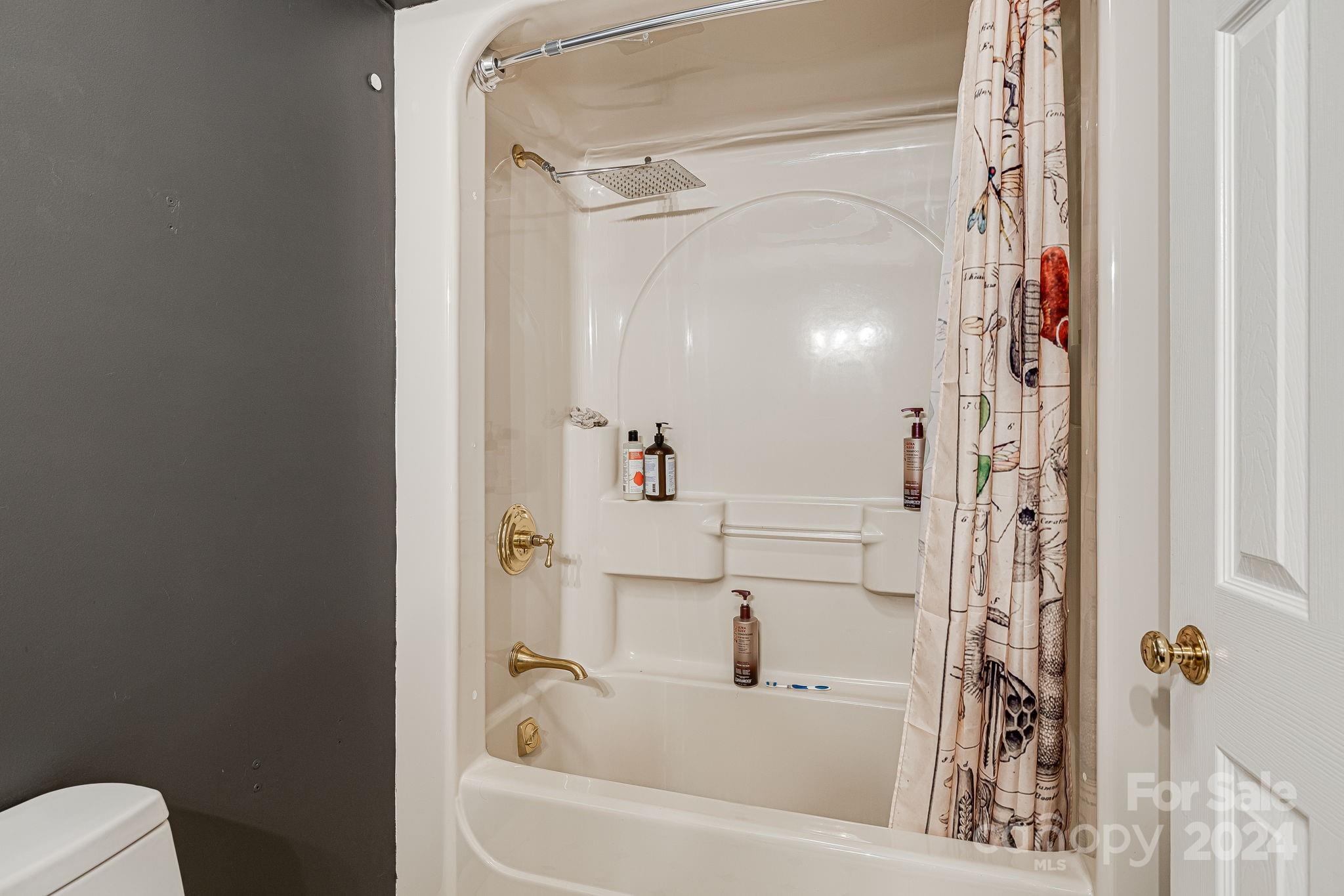 116 Holcombe Cove Road Candler, NC 28715 - Photo 26 of 31 a bathroom with a bathtub and a shower