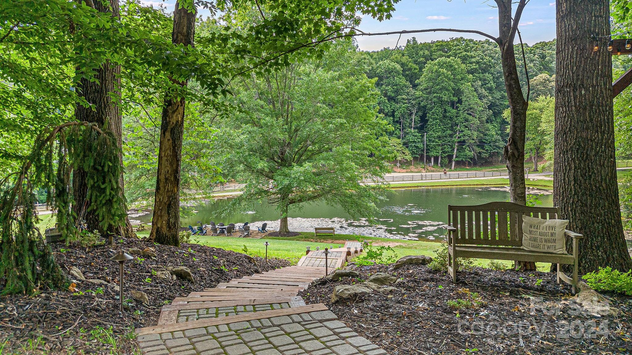 116 Holcombe Cove Road Candler, NC 28715 - Photo 28 of 31 a view of a bench in a garden
