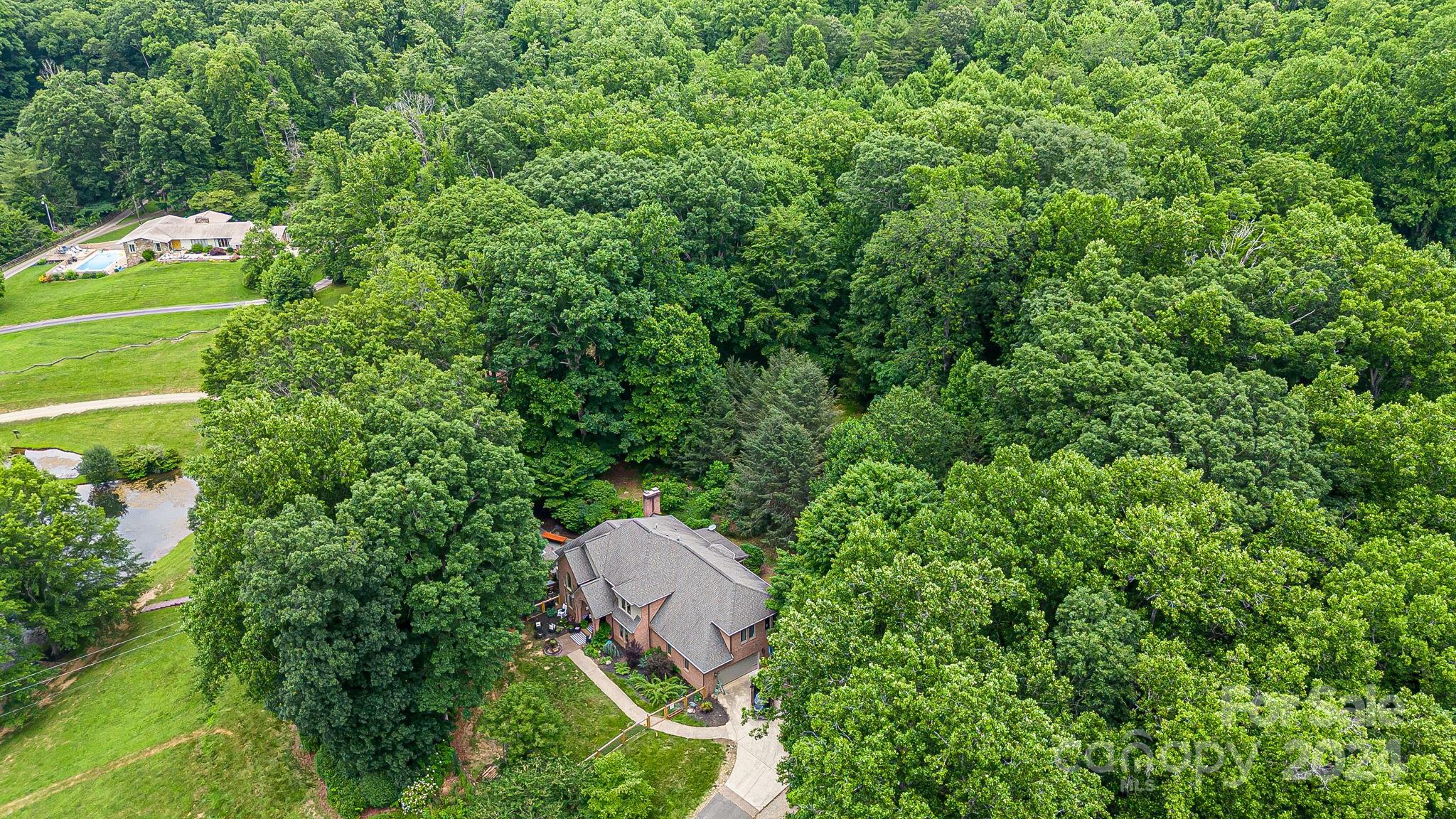 116 Holcombe Cove Road Candler, NC 28715 - Photo 31 of 31 an aerial view of a house with a yard