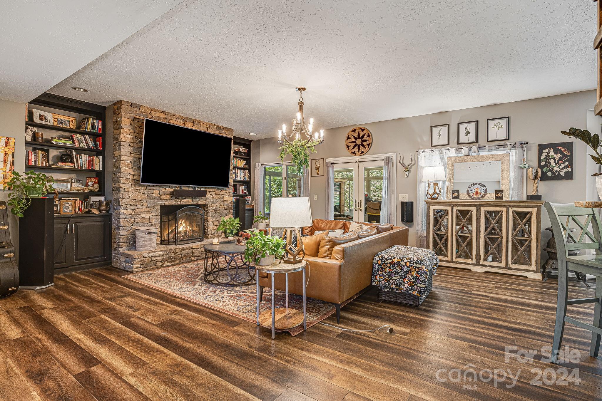 116 Holcombe Cove Road Candler, NC 28715 - Photo 5 of 31 a living room with fireplace furniture and a flat screen tv