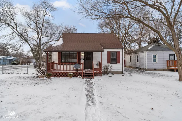a view of a house with a yard covered in snow