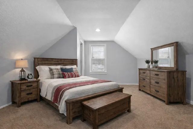 a bedroom with a bed and a dresser