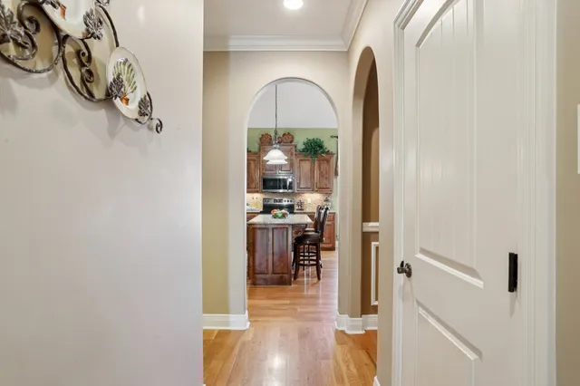 a kitchen with stainless steel appliances granite countertop a sink a stove and a wooden cabinets
