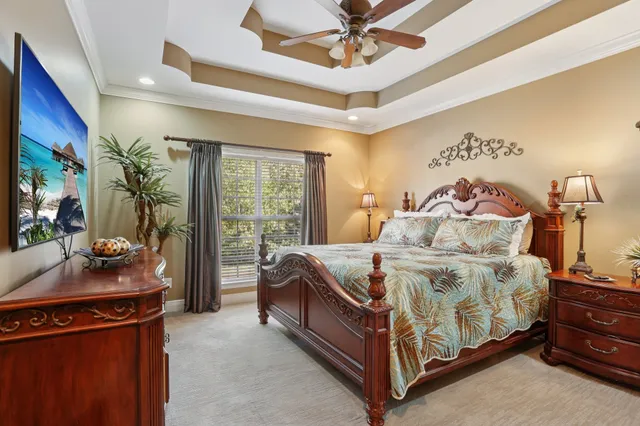 a spacious bedroom with a bed and a chandelier