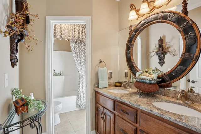 a view of a house with a small yard plants and large tree