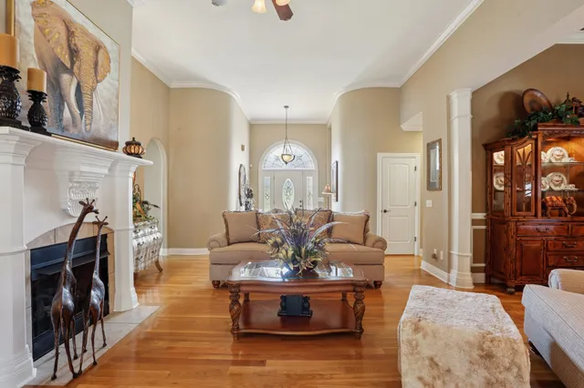 a living room with furniture and a wooden floor