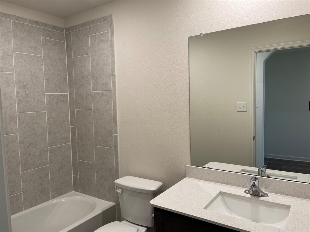 3010 McCoy Road Forney, TX 75126 - Photo 8 of 24 a bathroom with a sink a toilet and shower
