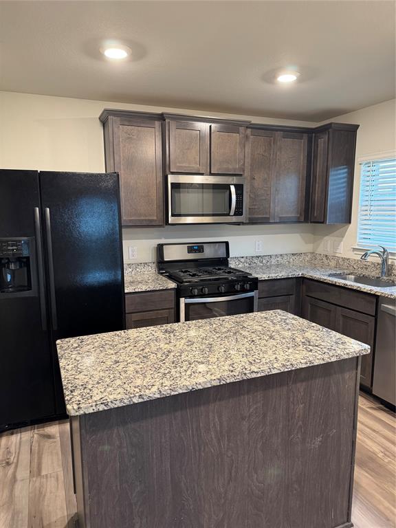 3010 McCoy Road Forney, TX 75126 - Photo 9 of 24 a kitchen with a stove refrigerator and microwave