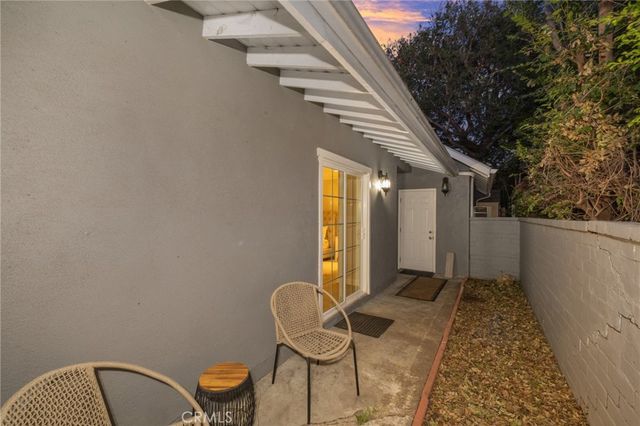 a backyard of a house with table and chairs