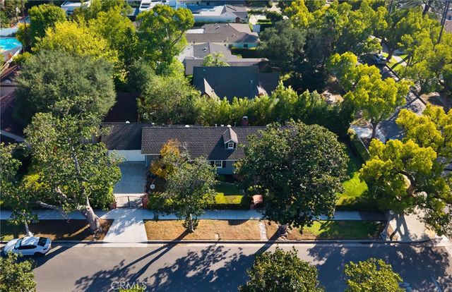 an aerial view of a house with yard swimming pool and outdoor seating