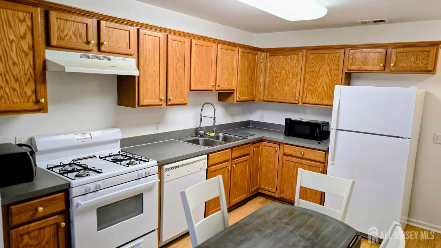 205 Liddle Avenue Edison, NJ 08837 - Photo 6 of 32 a kitchen with stainless steel appliances granite countertop a stove a sink dishwasher and a refrigerator