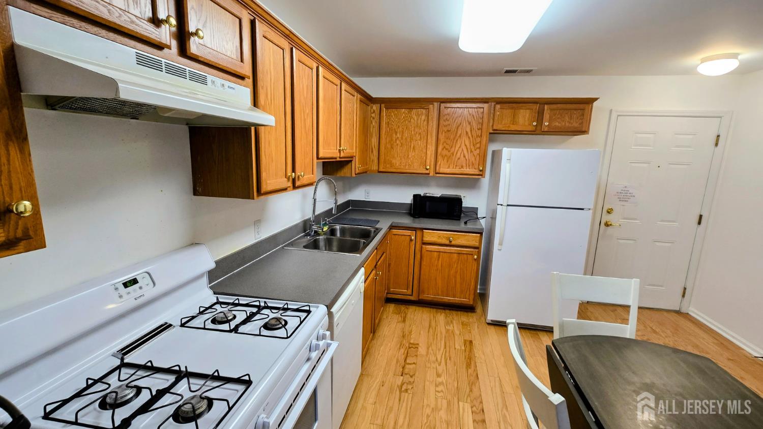 205 Liddle Avenue Edison, NJ 08837 - Photo 7 of 32 a kitchen with a sink a stove and a refrigerator