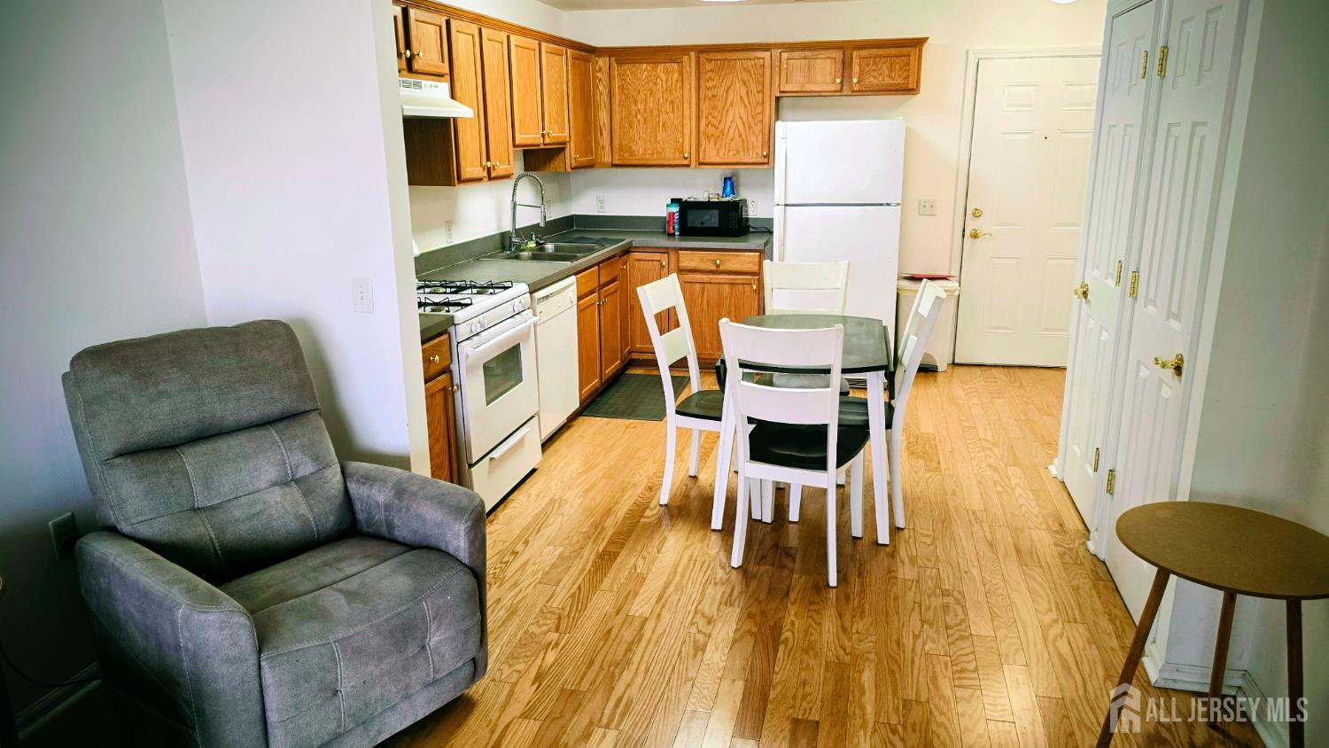 205 Liddle Avenue Edison, NJ 08837 - Photo 8 of 32 a living room with stainless steel appliances furniture a wooden floor and a window