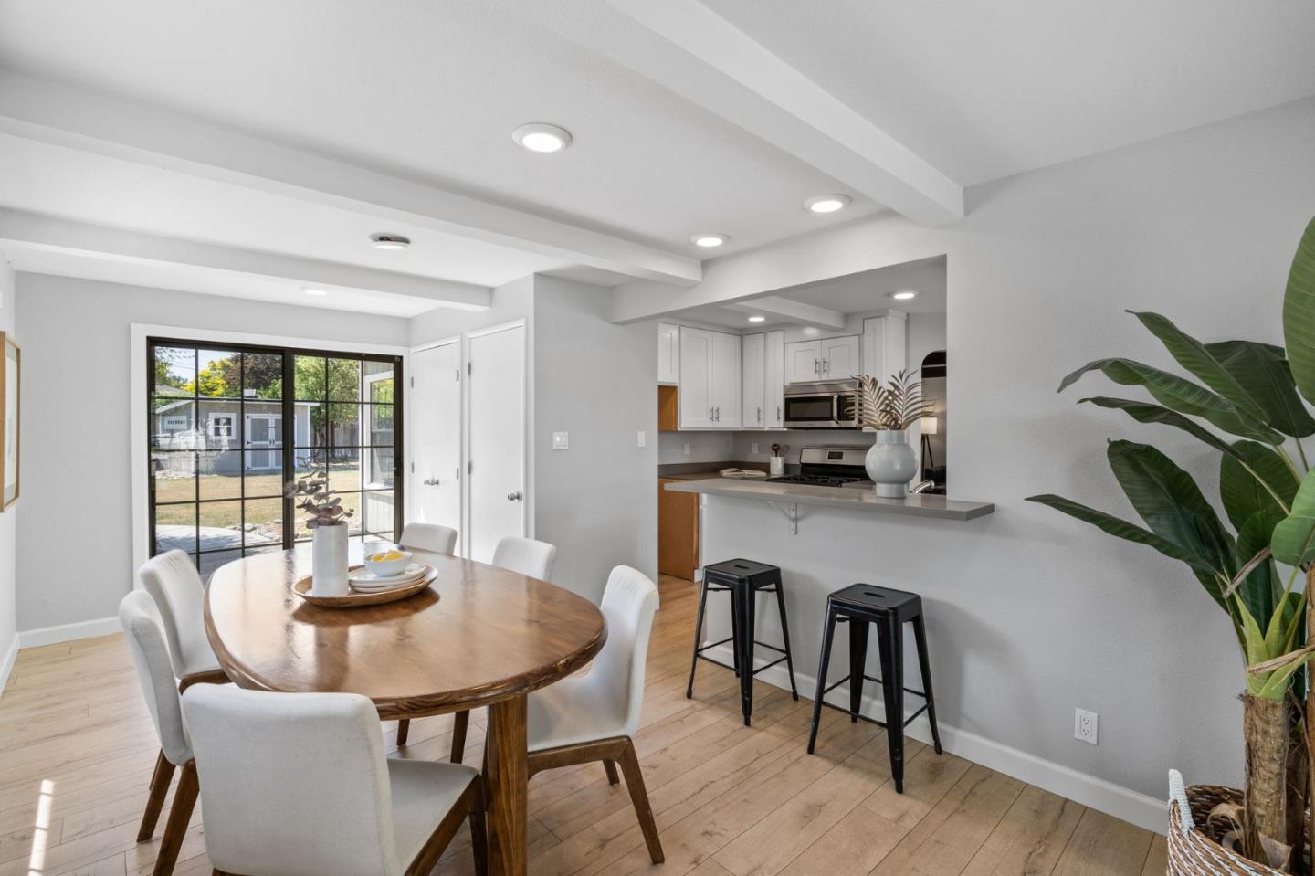 1363 Ramon Drive Sunnyvale, CA 94087 - Photo 15 of 36 a kitchen with a table chairs and white cabinets